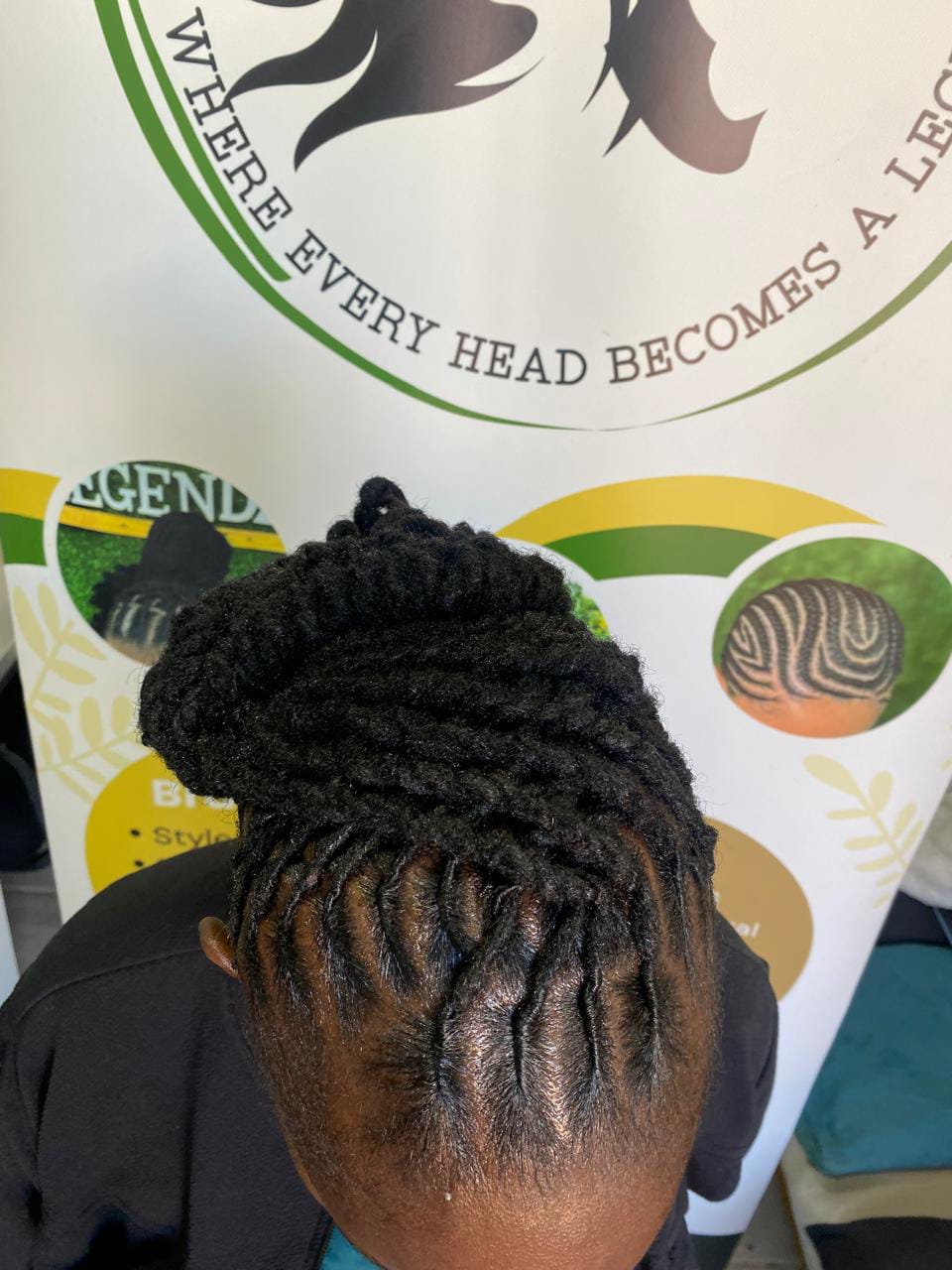 Top view of locs twisted back from the hairline into a coiled updo