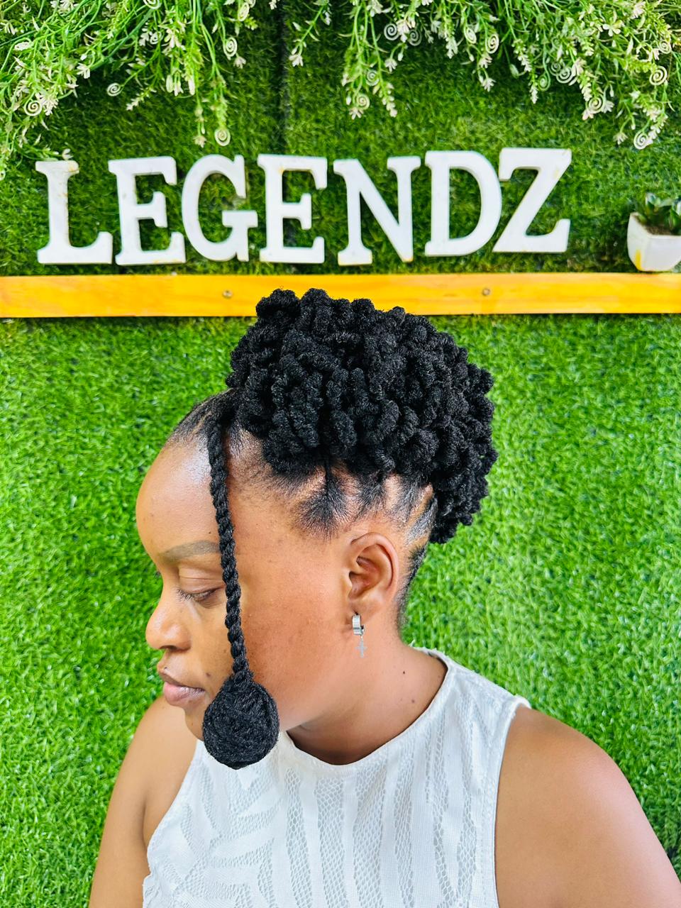 Curled loc updo with a single long twist falling at the front
