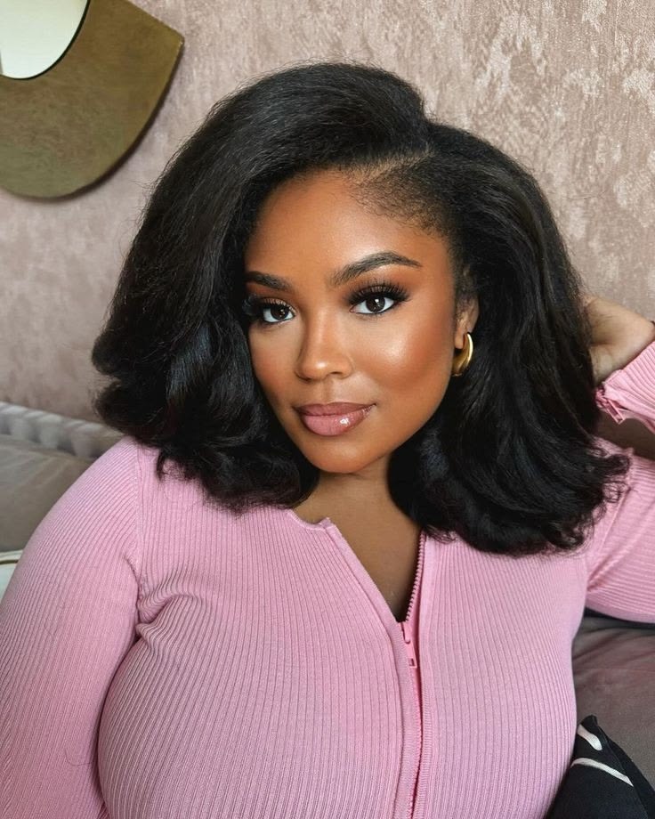 Shoulder-length natural hair blown out full and smooth