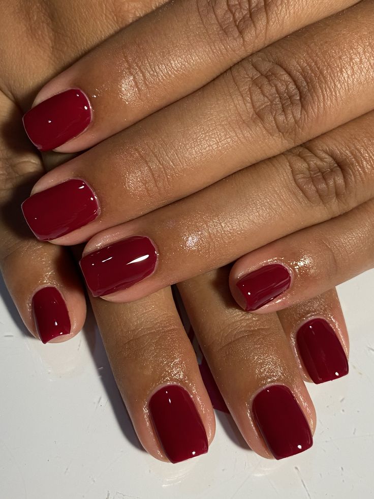Short natural nails in glossy deep-red gel